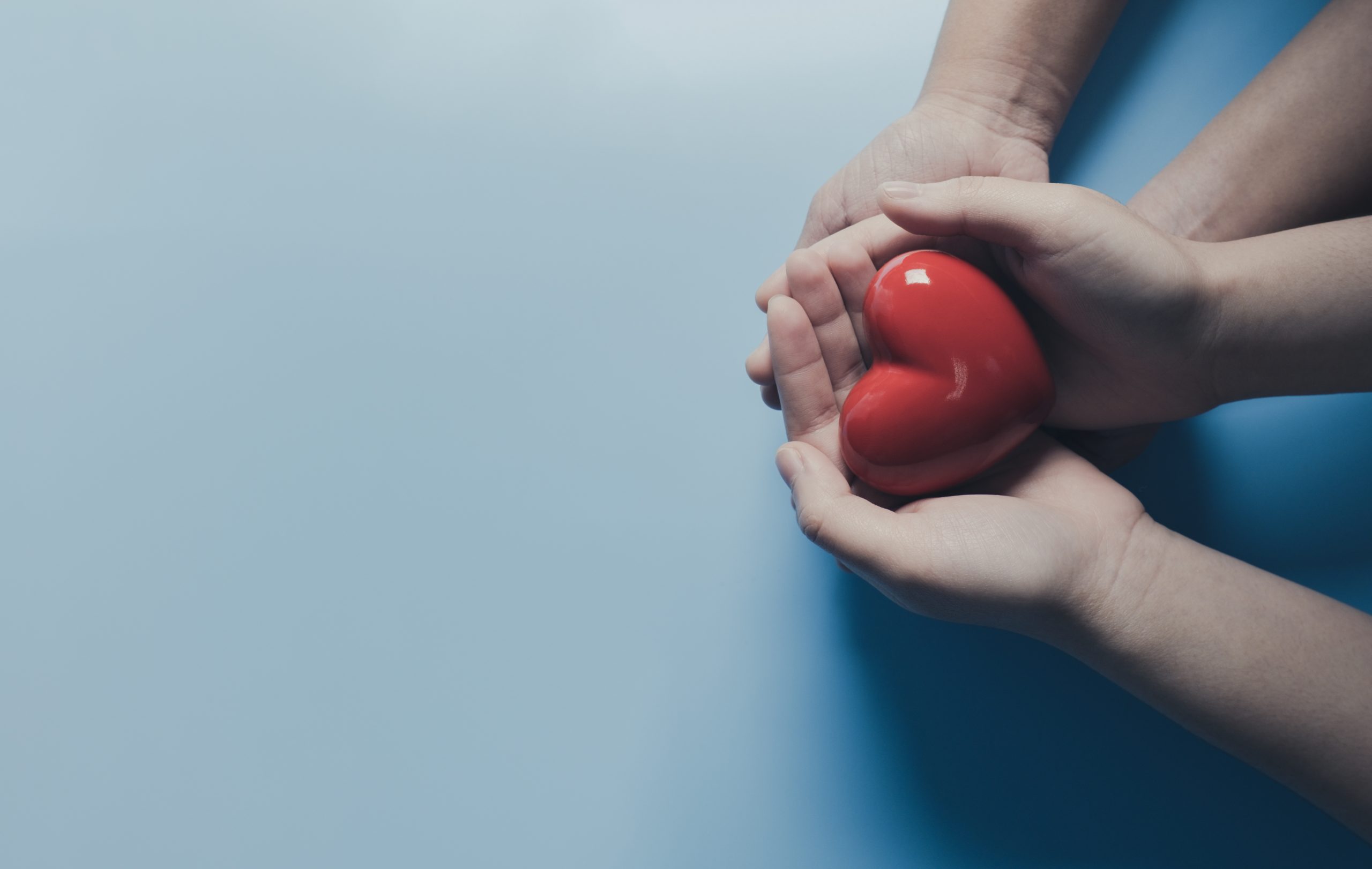 Hands holding a red heart